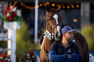 Groom and horse waiting by the ring at Desert International Horse Park