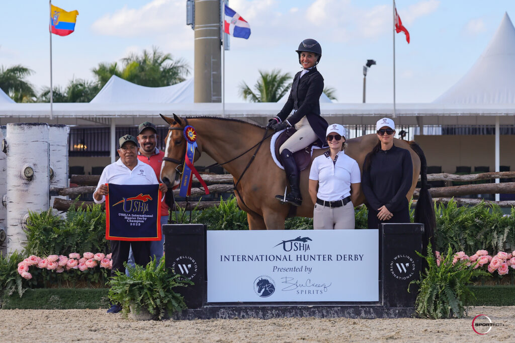 With Remi on her side, Emily Williams & Damas de Tannerre were presented as winners of the $25,000 USHJA International Hunter Derby, Presented by BluCreeq Spirits. Photo ©Sportfot